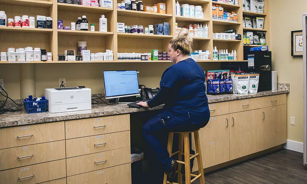 photo of a woman working in a pharmacy