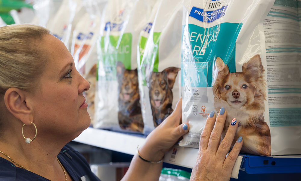 photo of woman looking at dog food