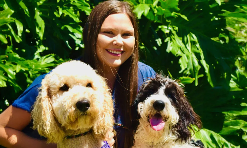 photo of a woman with two dogs