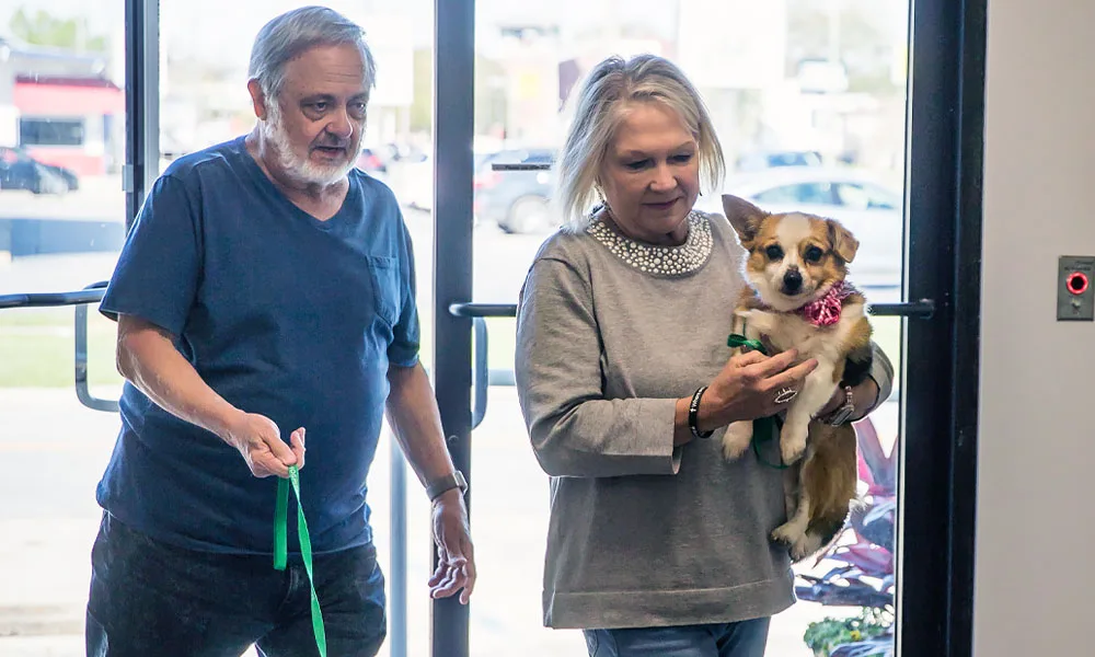 family holding their dog