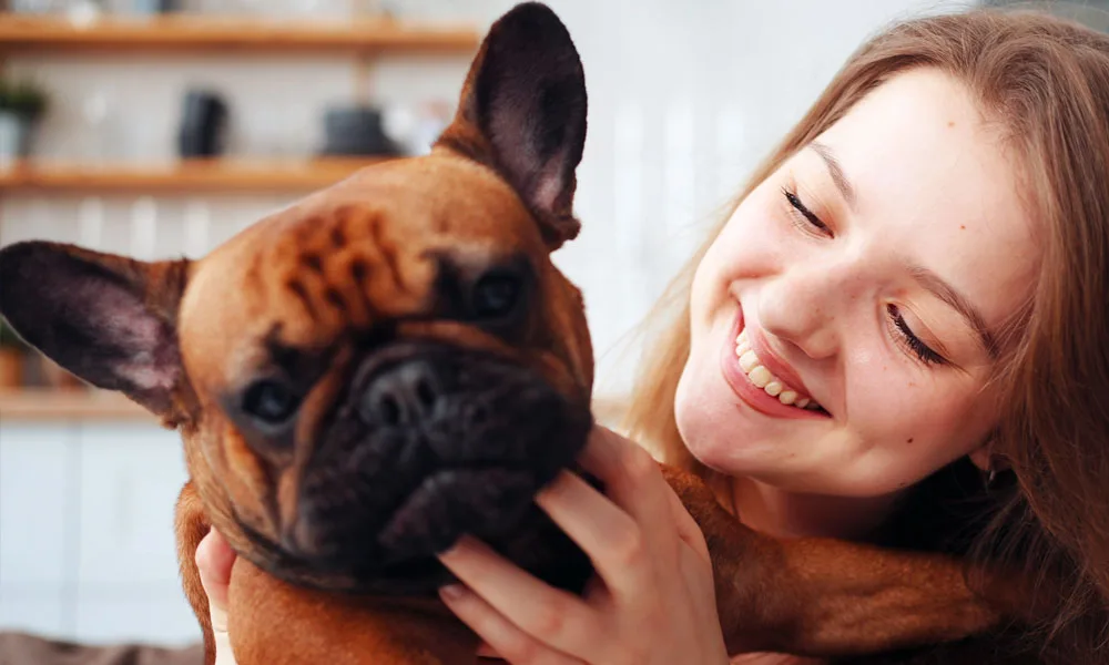 cheerful woman with a french bulldog